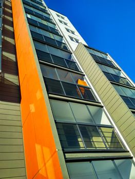 Part of a multi-storey residential building with loggias against the blue sky.