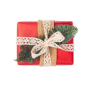 Wrapped vintage christmas gift box with red ribbon bow, isolated on white