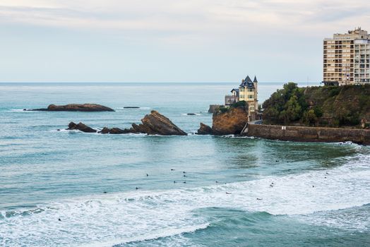 Atlantic Ocean in Biarritz, France. Surfers in the sea.