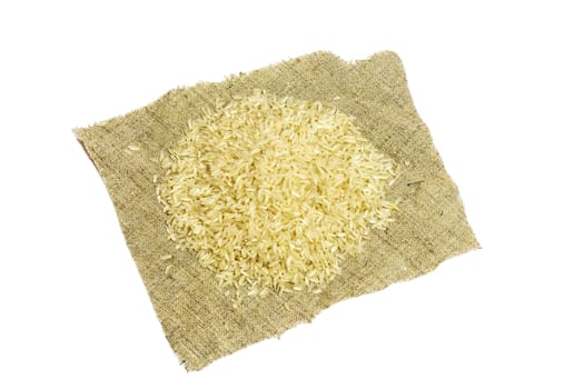 On a white background there is a napkin with a handful of rice croup