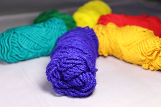 multiple colored yarn stock on white background