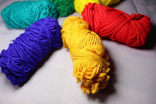 multiple colored yarn stock on white background