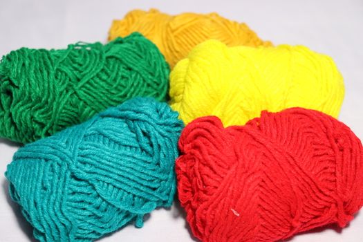 multiple colored yarn stock on white background