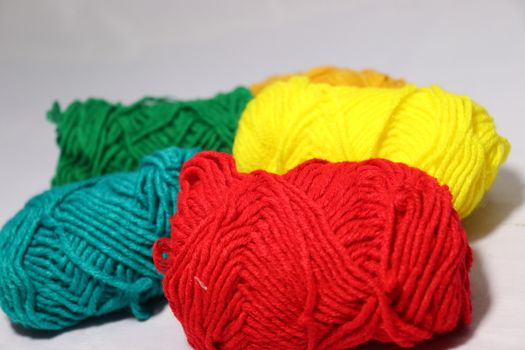 multiple colored yarn stock on white background