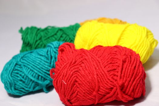 multiple colored yarn stock on white background