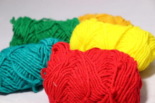 multiple colored yarn stock on white background