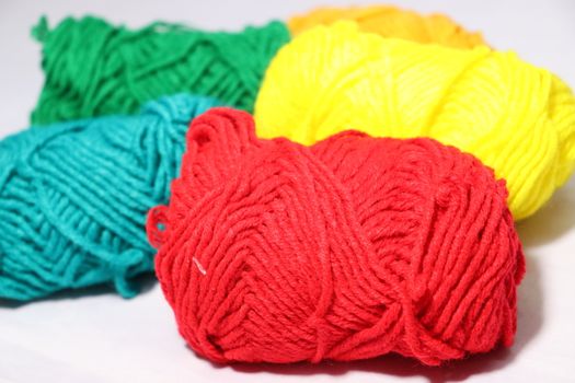 multiple colored yarn stock on white background