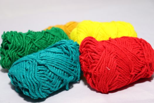 multiple colored yarn stock on white background