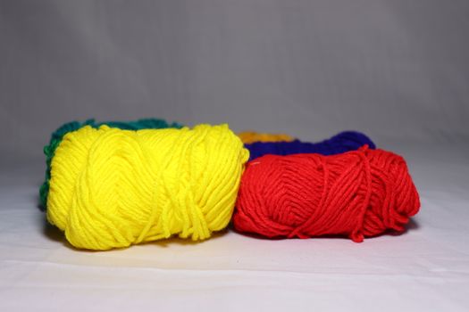multiple colored yarn stock on white background