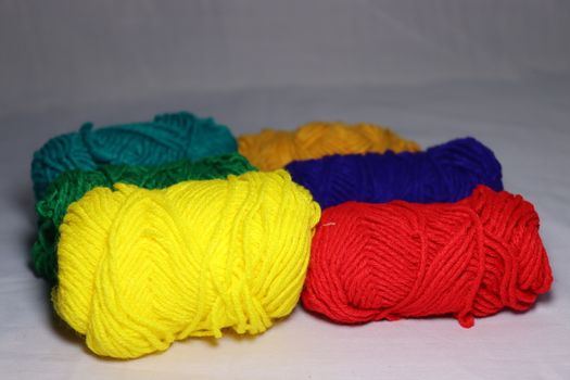 multiple colored yarn stock on white background