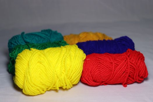multiple colored yarn stock on white background