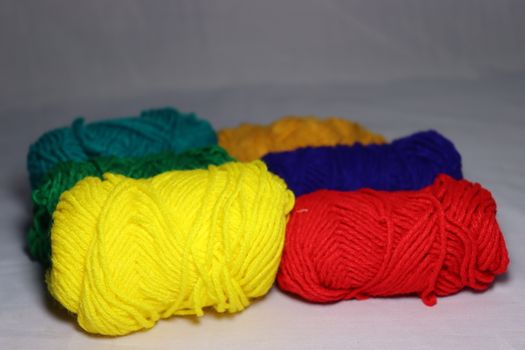multiple colored yarn stock on white background