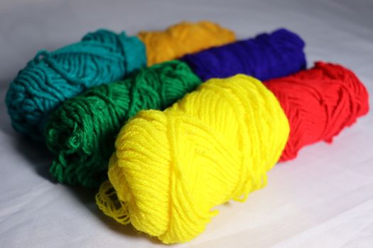 multiple colored yarn stock on white background