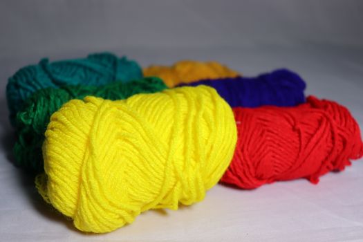 multiple colored yarn stock on white background