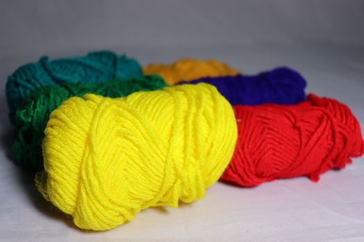 multiple colored yarn stock on white background