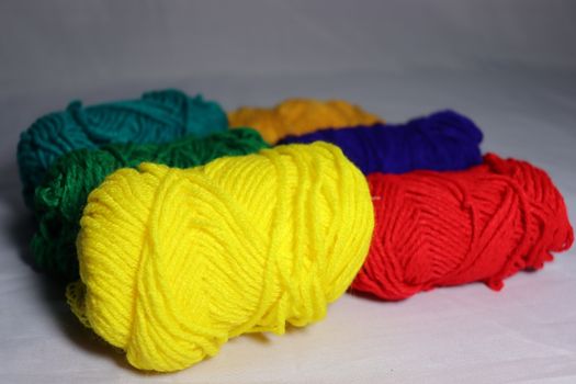 multiple colored yarn stock on white background