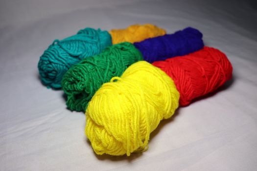 multiple colored yarn stock on white background