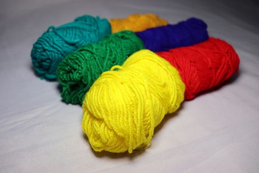 multiple colored yarn stock on white background
