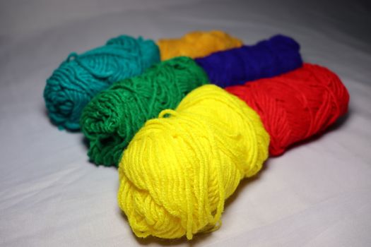 multiple colored yarn stock on white background
