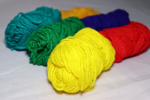 multiple colored yarn stock on white background