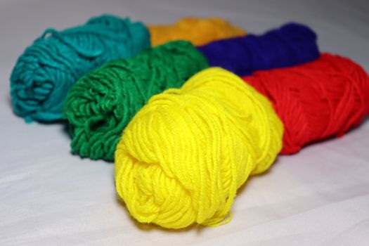 multiple colored yarn stock on white background