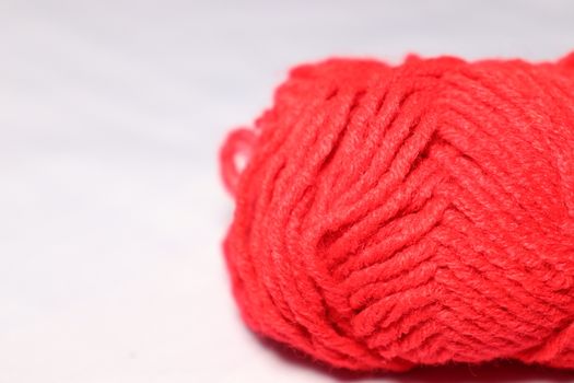 red colored yarn closeup on white background