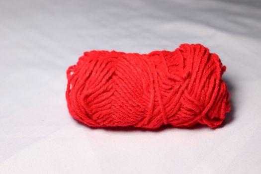 red colored yarn closeup on white background