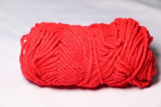 red colored yarn closeup on white background
