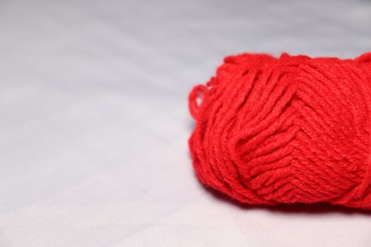red colored yarn closeup on white background