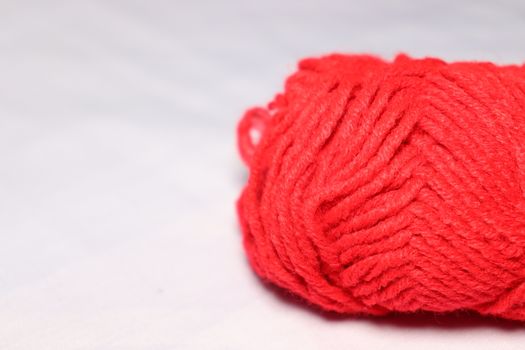 red colored yarn closeup on white background