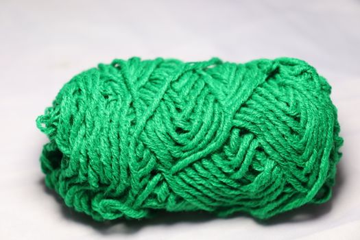 green colored yarn closeup on white background