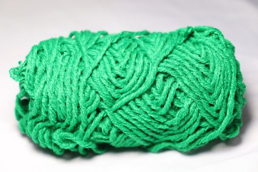 green colored yarn closeup on white background