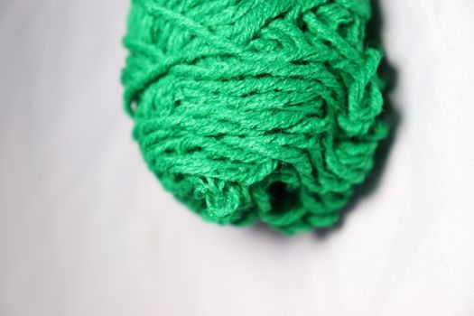 green colored yarn closeup on white background