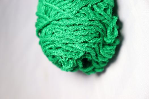 green colored yarn closeup on white background