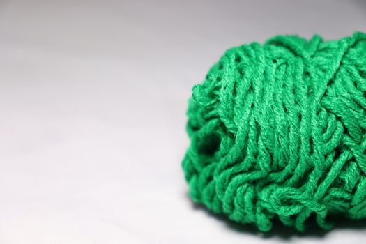 green colored yarn closeup on white background