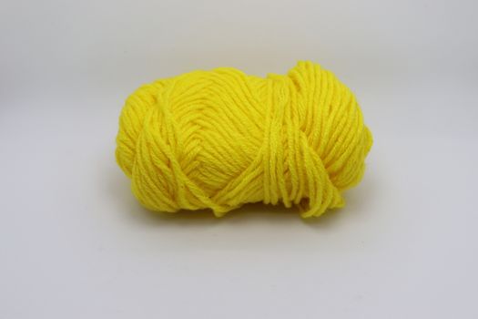 yellow colored yarn closeup on white background