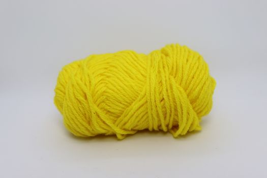 yellow colored yarn closeup on white background