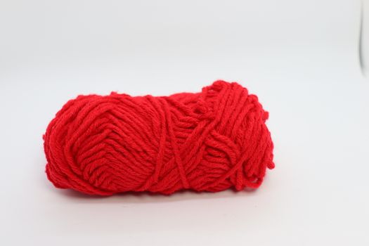 red colored yarn closeup on white background