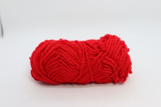 red colored yarn closeup on white background