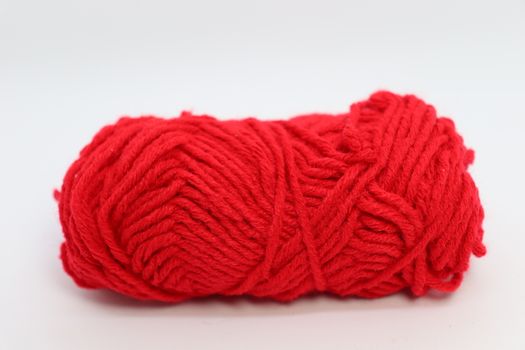 red colored yarn closeup on white background