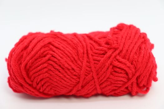 red colored yarn closeup on white background