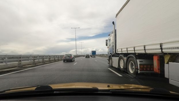 Driving on a highway point of view and overtaking a truck