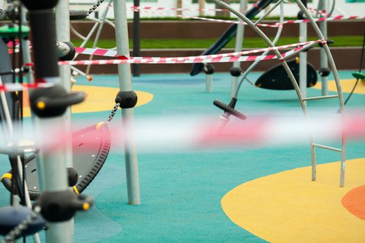 Restricted entrance to park or exercise workout playground, equipment wrapped with barricade tape, closed and shut down area due to Coronavirus COVID-19 corona virus disease pandemic outbreak crisis