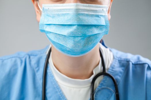 Closeup of doctor in blue uniform wearing blue protective surgical mask,COVID-19 Coronavirus disease,global pandemic outbreak, deadly Wuhan SARS-CoV-2 epidemic social physical distancing illustration