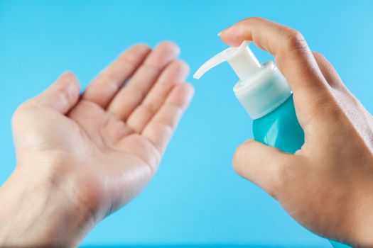 Female caucasian person applying dry wash antibacterial sanitizer gel on hands, increased personal hygiene after global Coronavirus COVID-19 virus disease, prevention and protection from spreading