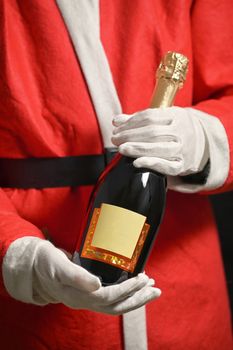 Conceptual Santa Claus Celebrating With Champagne Bottle