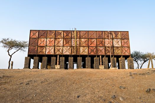 Abandoned, old water tank on a hill in Dighi, Pune made of steel plates belonging to Appleby-Frodingham England