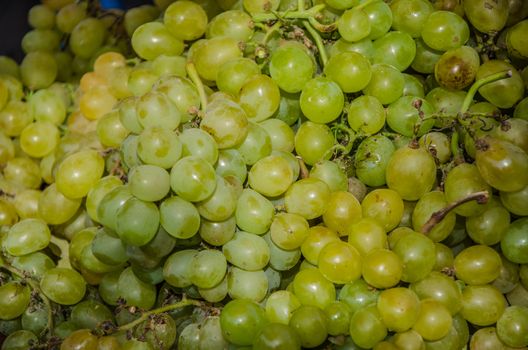 Background of green grapes with their stems