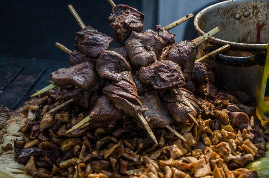 Traditional Peruvian food called anticuchos grilled skewered beef heart meat with boiled potato and white corn