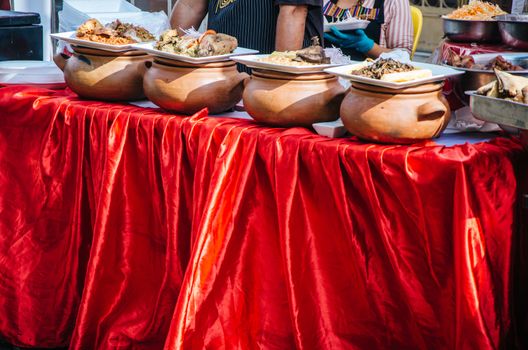 Clay pots with traditional Peruvian food at a gastronomic fair